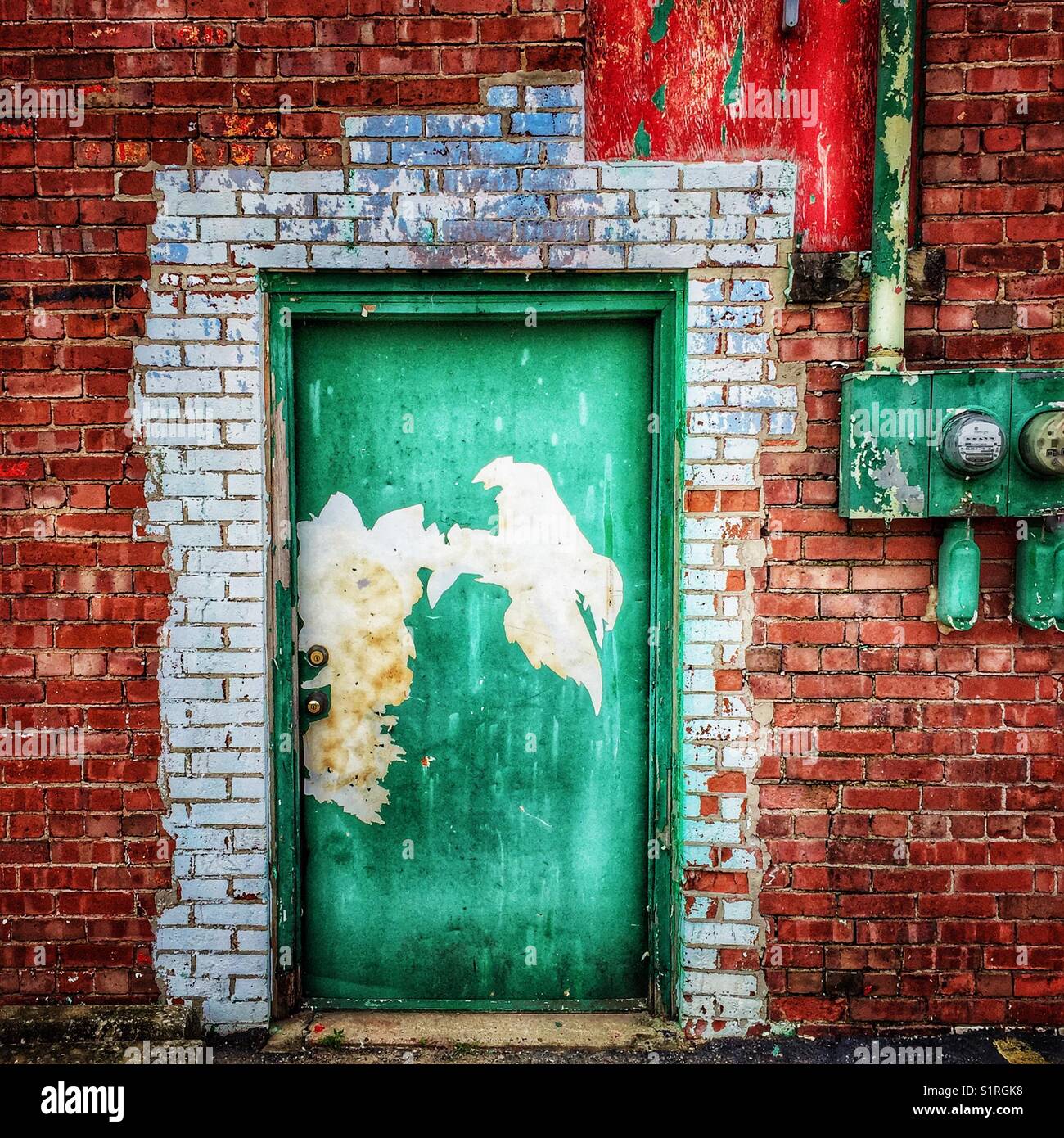 Weathered green door on old brick building - Smartphone Captured Stock Image