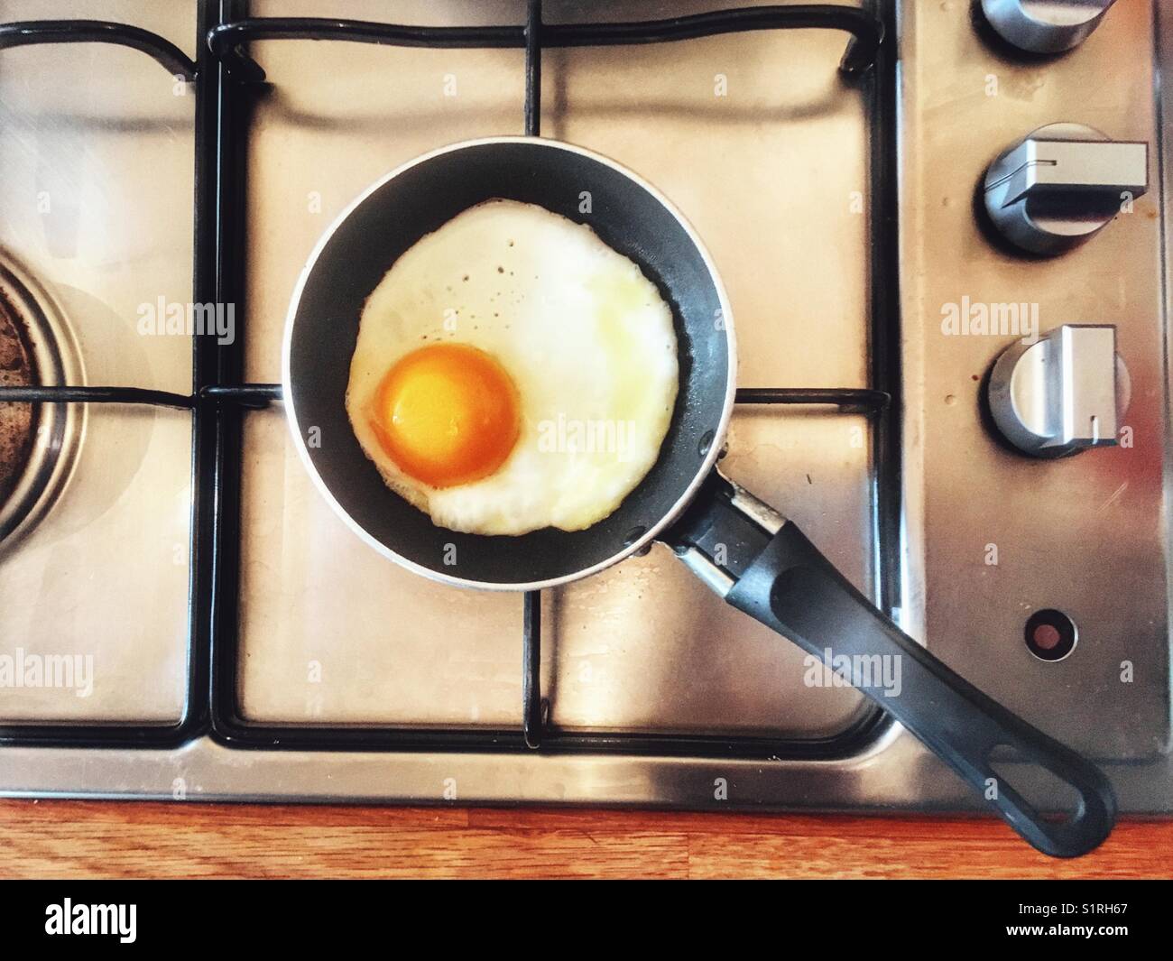 One egg frying pan on gas hob Stock Photo Alamy