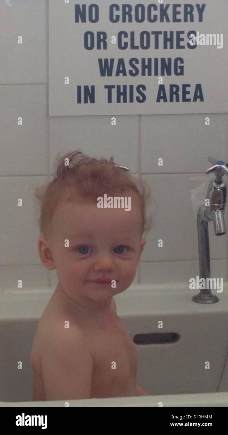Baby boy age 1 having a bath in the basin sink Stock Photo Alamy