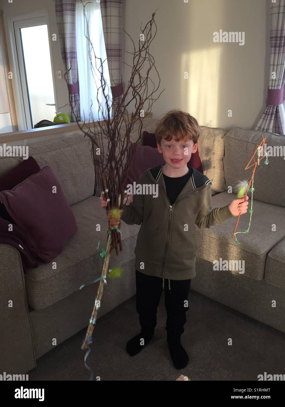 5 year old boy just made a witches broom for Halloween 2017. Stock Photo