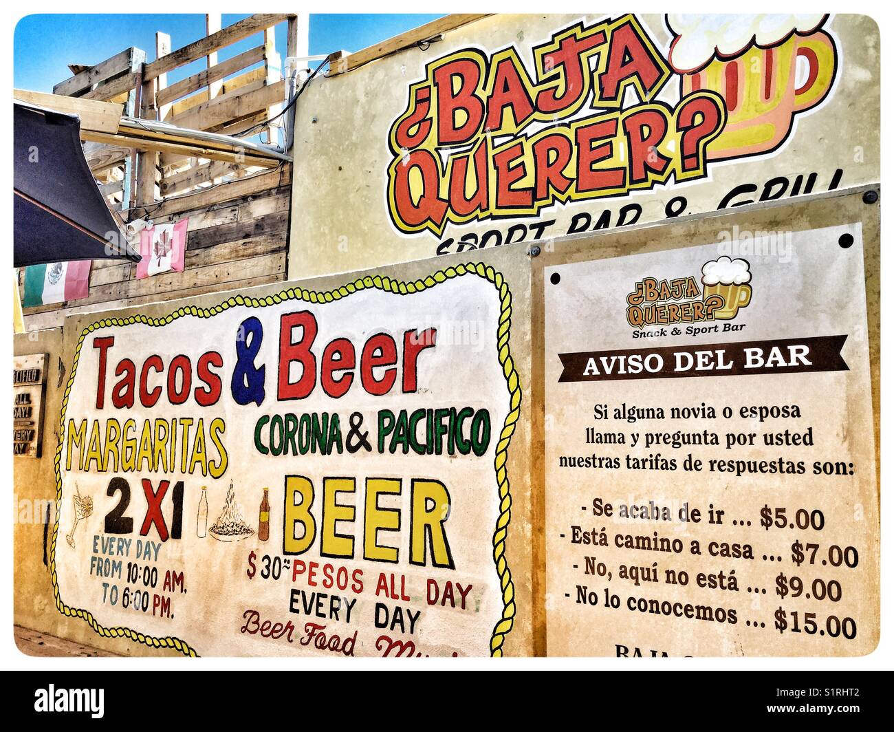 Outdoor bar advertises with large signs on their wall. - Smartphone Captured Stock Image