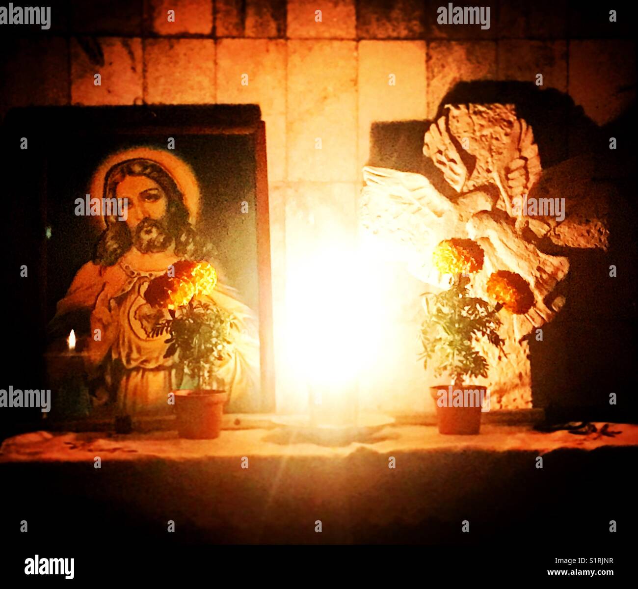 An image of Jesus Christ and marigold flowers during Day of the Dead in San Gregorio Atlapulco, Xochimilco, Mexico City. - Smartphone Captured Stock Image