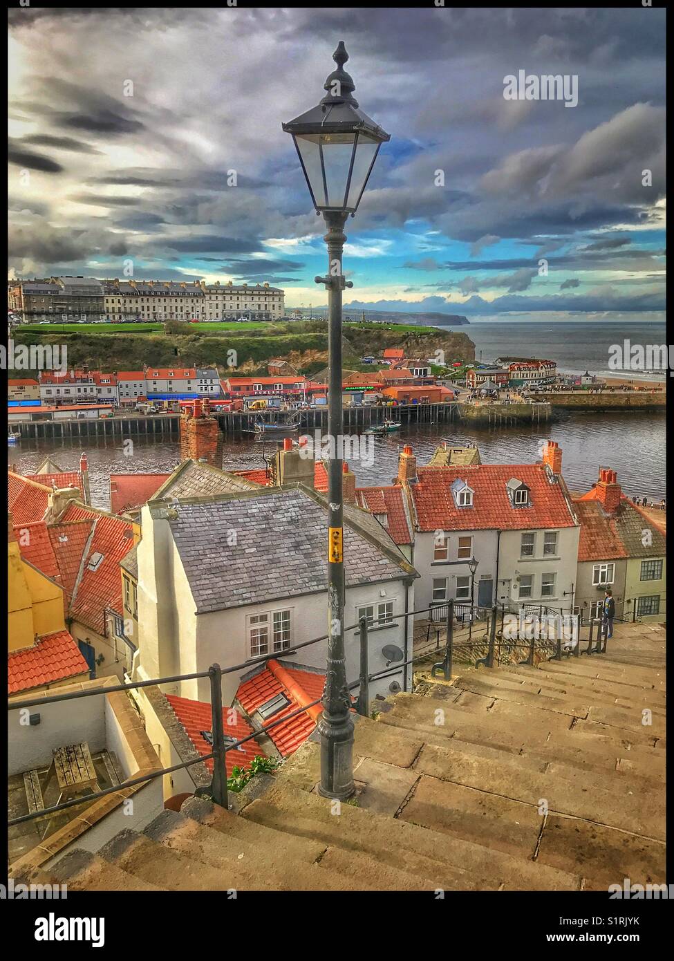 England, Yorkshire - a view of Whitby Old Town & Harbour from the famous 199 steps that link the Old Town to St. Mary's Church. This area was the inspiration for Bram Stoker's Dracula. © COLIN HOSKINS - Smartphone Captured Stock Image