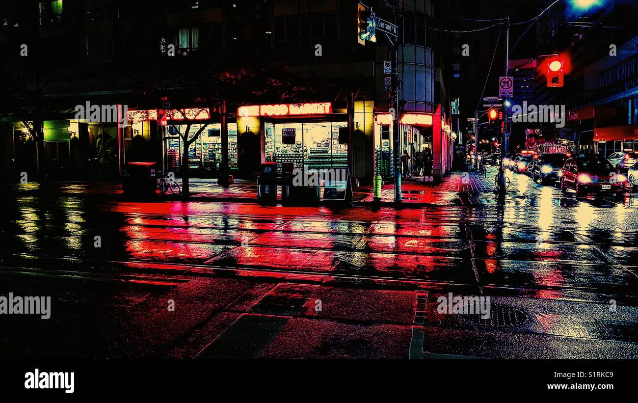 Car headlights and illuminated store fronts on wet night, Toronto, Ontario, Canada - Smartphone Captured Stock Image