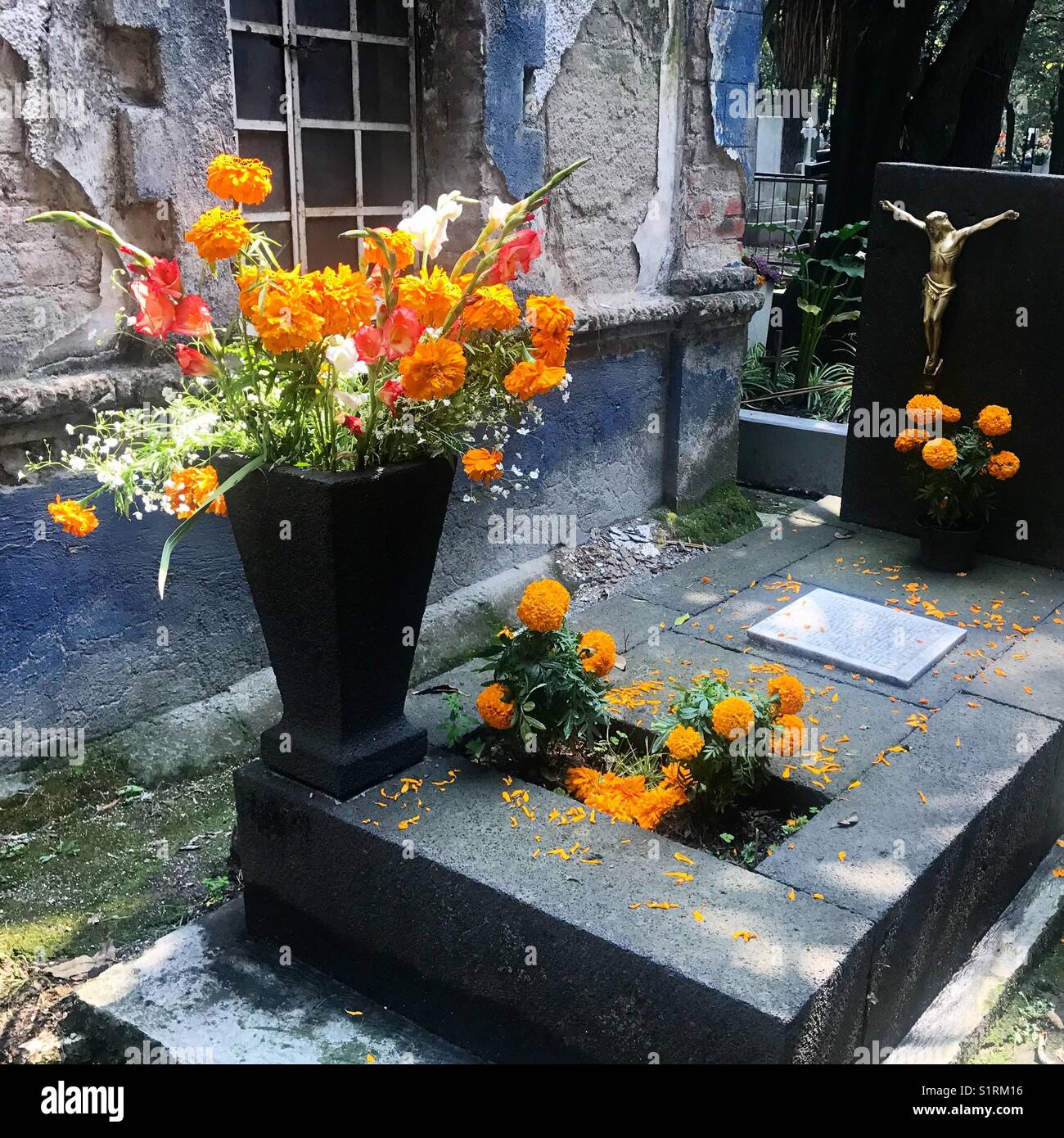 Marigold flowers decorate a tomb during Day of the Dead in Mexico City, Mexico - Smartphone Captured Stock Image