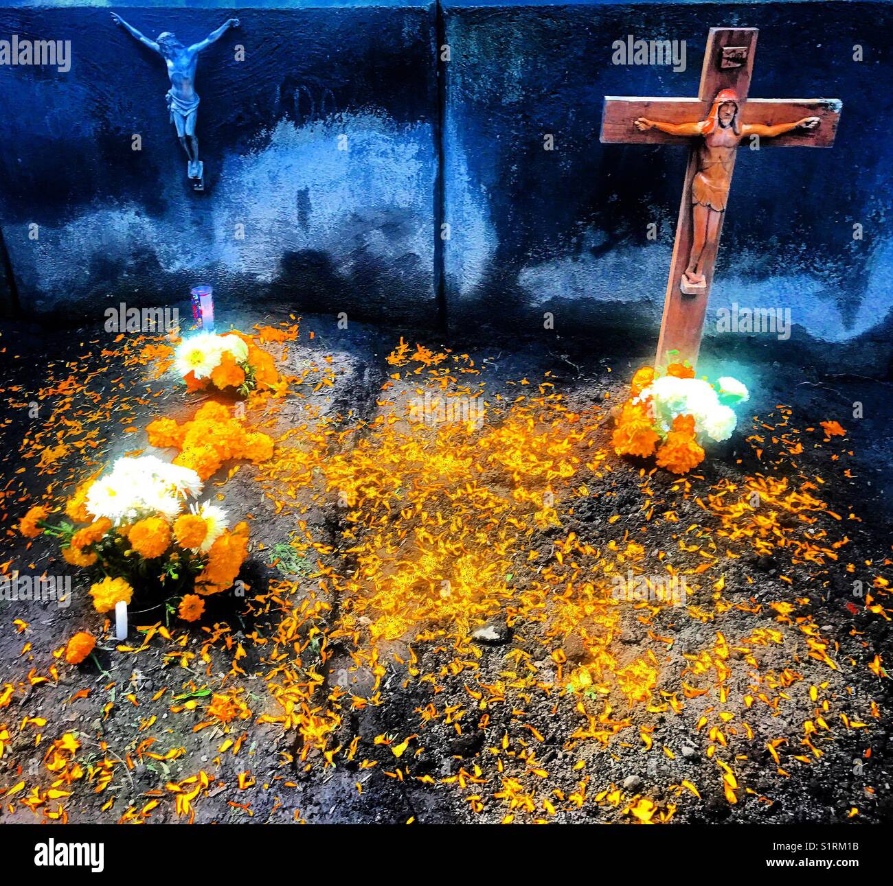 Crosses and marigold flowers decorate tombs during Day of the Dead in Mexico City, Mexico - Smartphone Captured Stock Image
