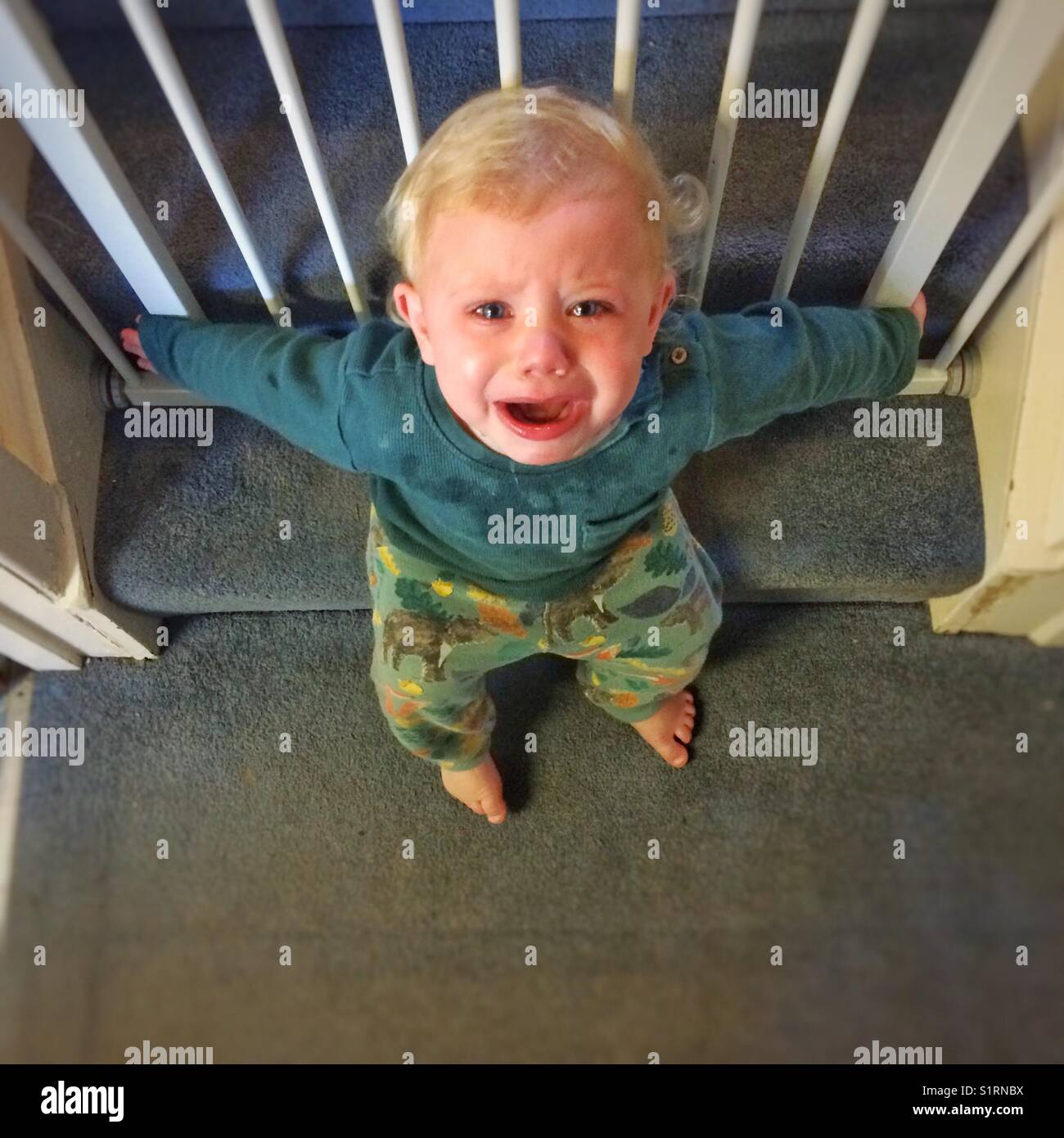 One year old boy sitting on the naughty step. Stock Photo
