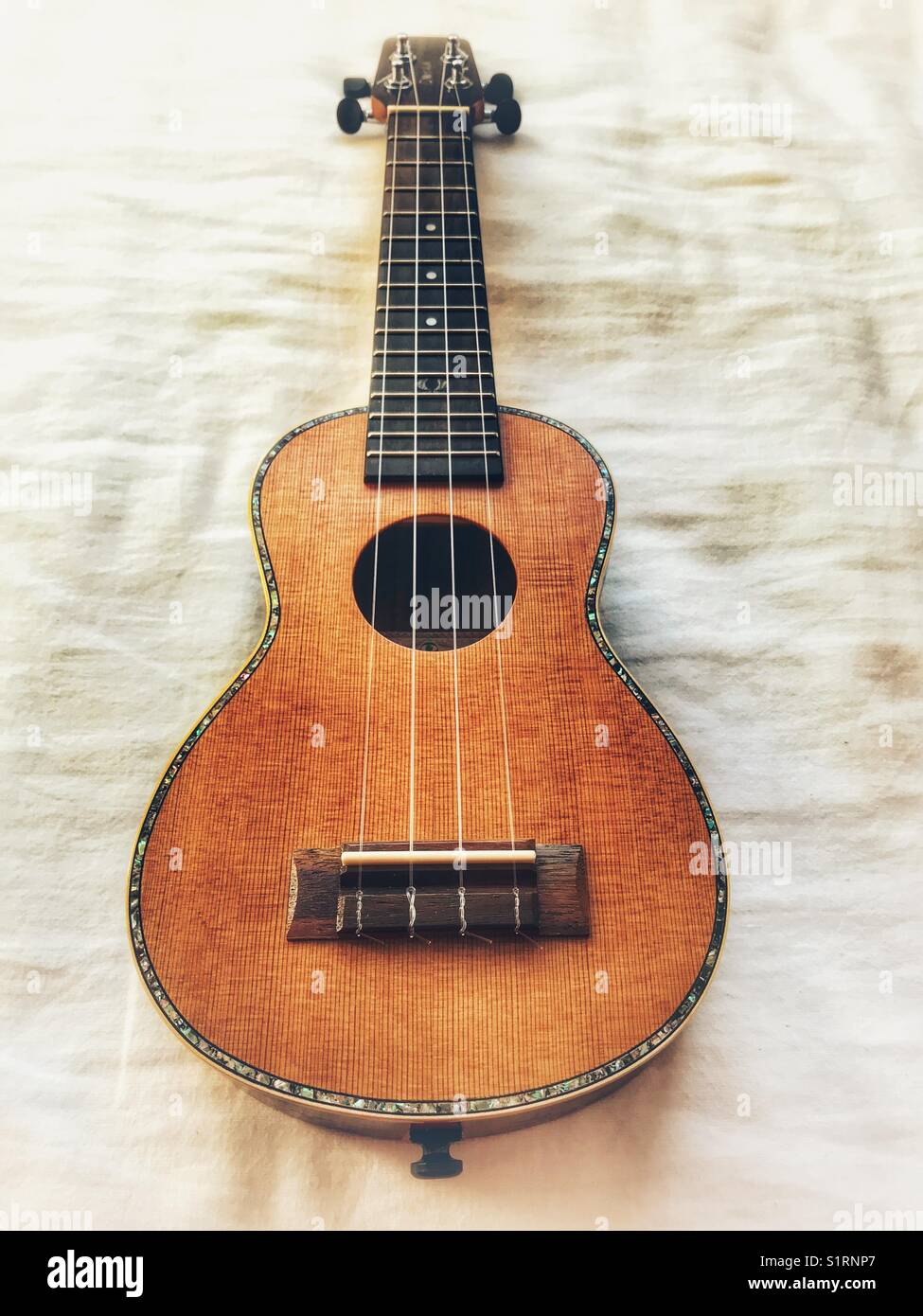 Soprano ukulele, cedar top. - Smartphone Captured Stock Image