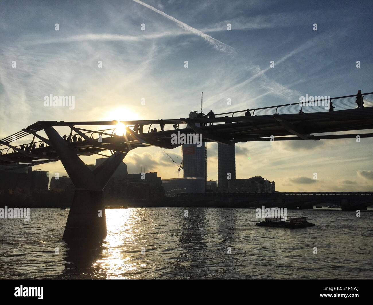 People cross the River Thames on Millennium Bridge in London, England on November 3 2017 - Smartphone Captured Stock Image