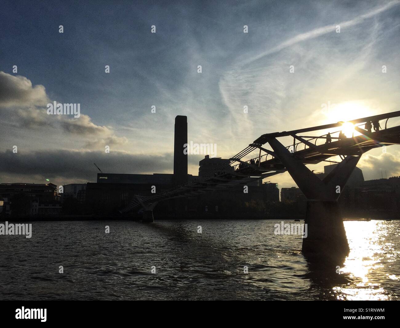 People cross the River Thames on Millennium Bridge in London, England on November 3 2017 - Smartphone Captured Stock Image