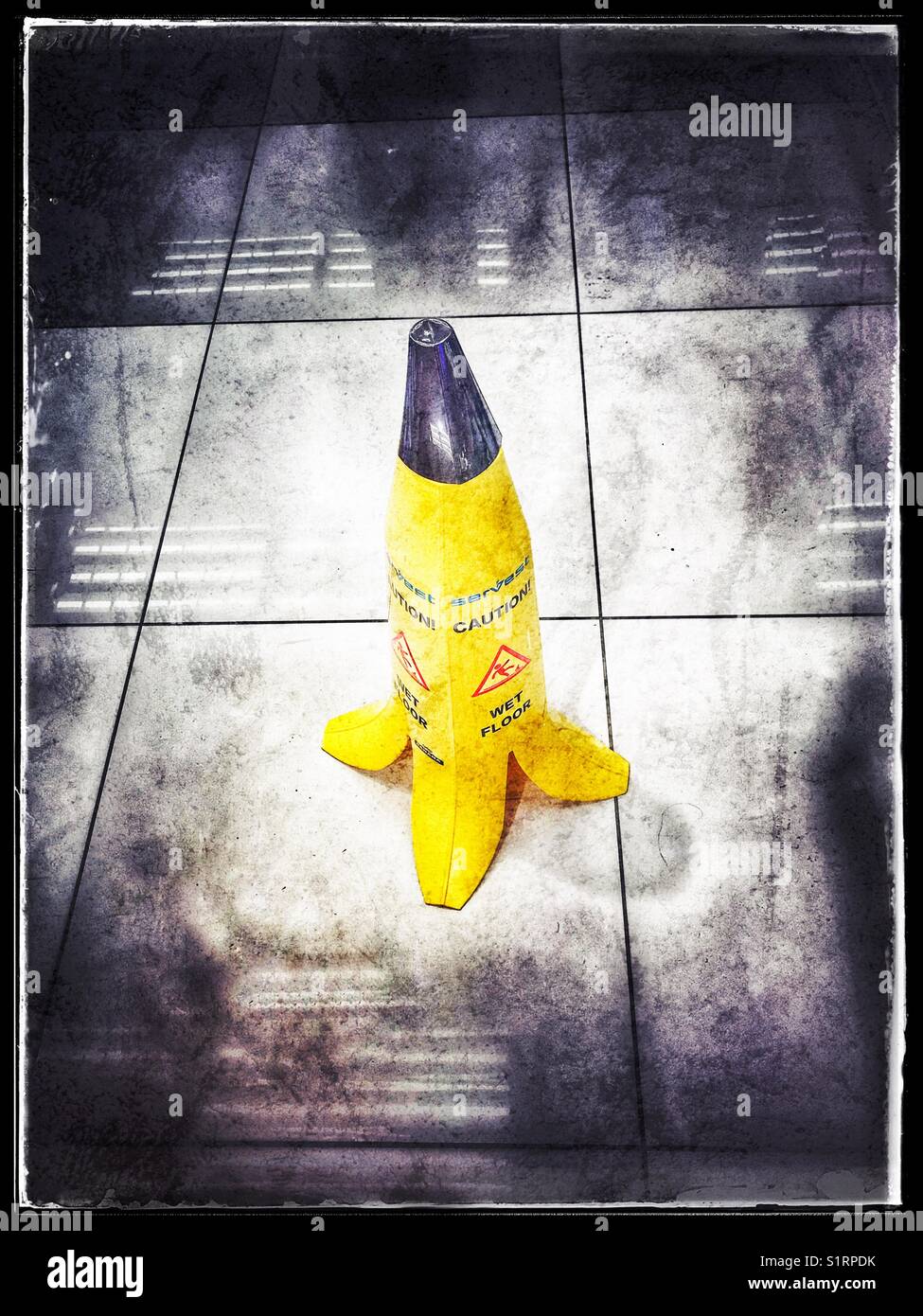 Caution Wet Floor Sign In Shape Of Peeled Banana Stock