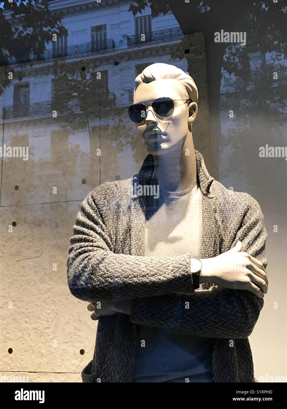 Mannequin crossing arms in a shop window. - Smartphone Captured Stock Image