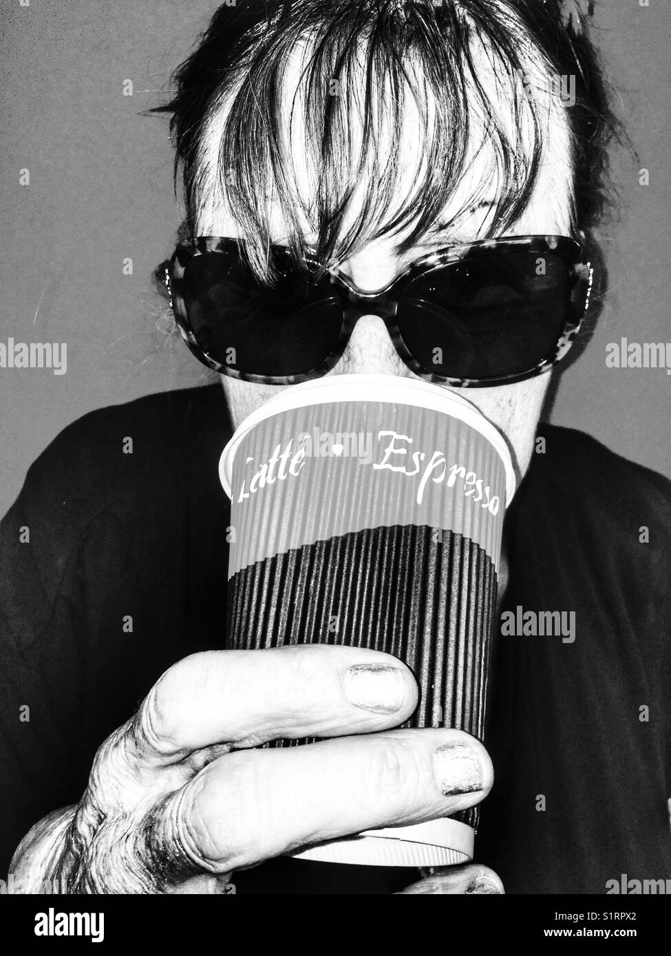 Woman drinking take away coffee - Smartphone Captured Stock Image