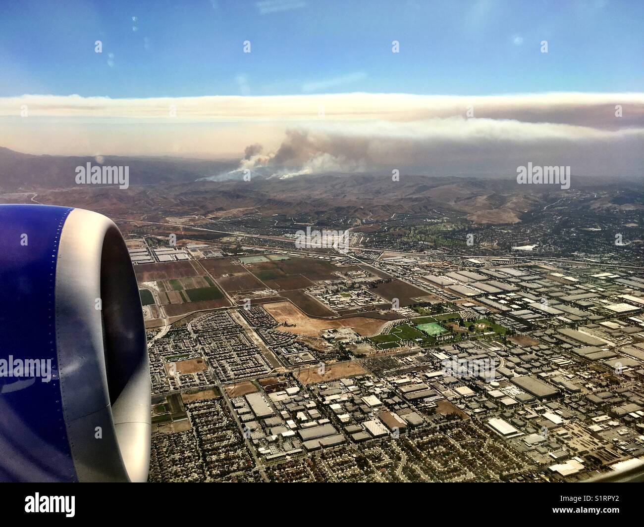 View of smoke from wildfires burning in Southern California at Anaheim Hills as seen from an airplane window. 9 October 2017 - Smartphone Captured Stock Image