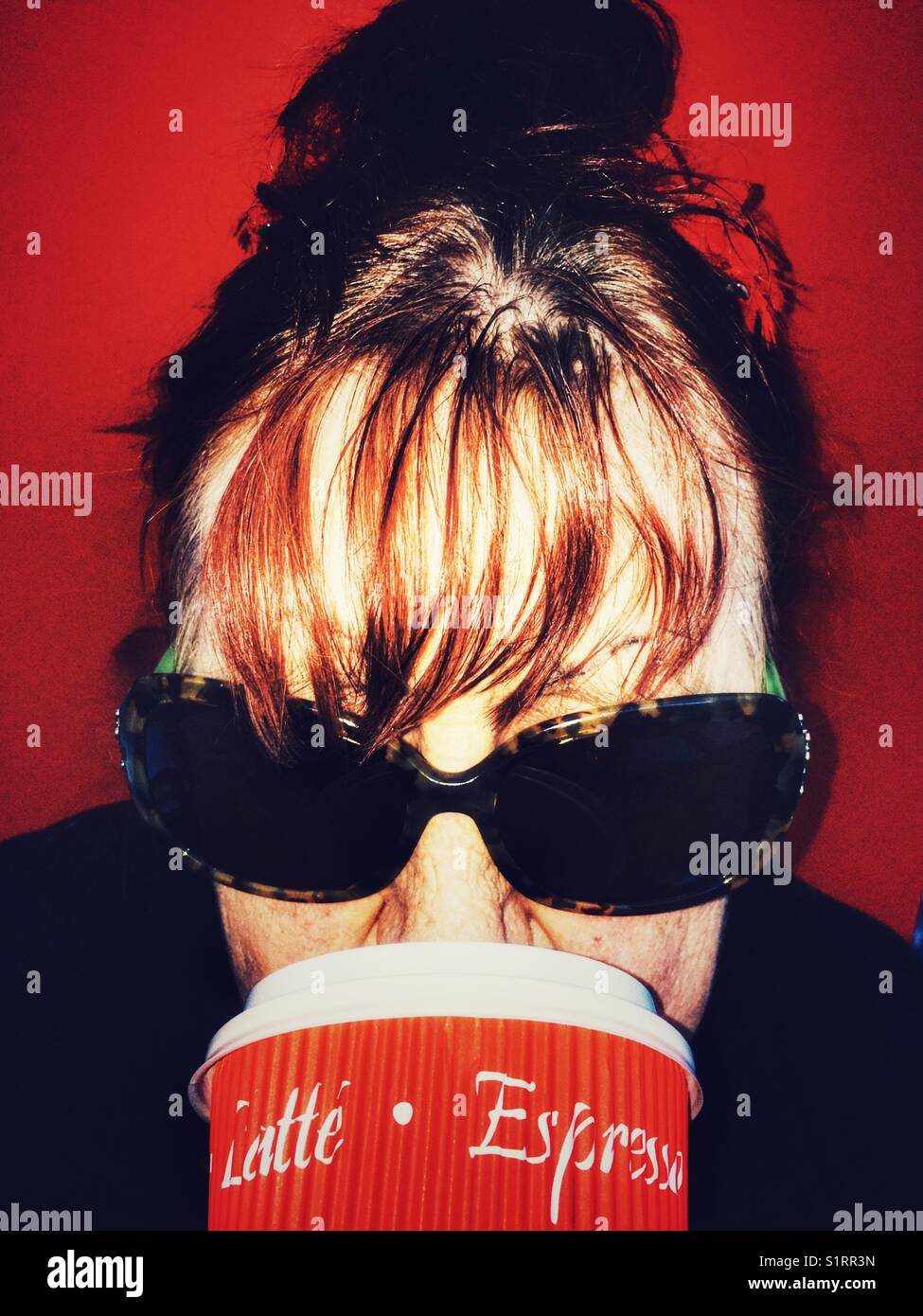 Woman drinking a take away coffee - Smartphone Captured Stock Image