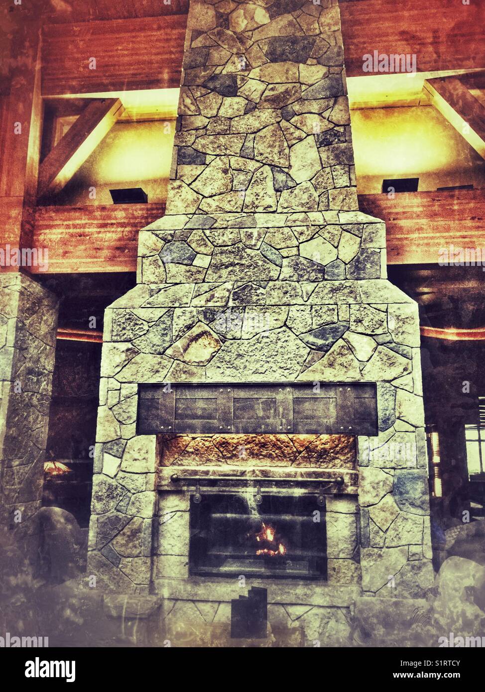 Cozy seating area in front of a cozy stone fireplace at Casino Rama, Ontario, Canada. - Smartphone Captured Stock Image