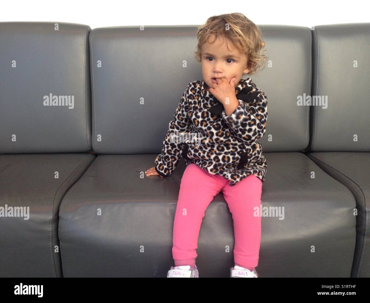 Toddler sitting Stock Photo