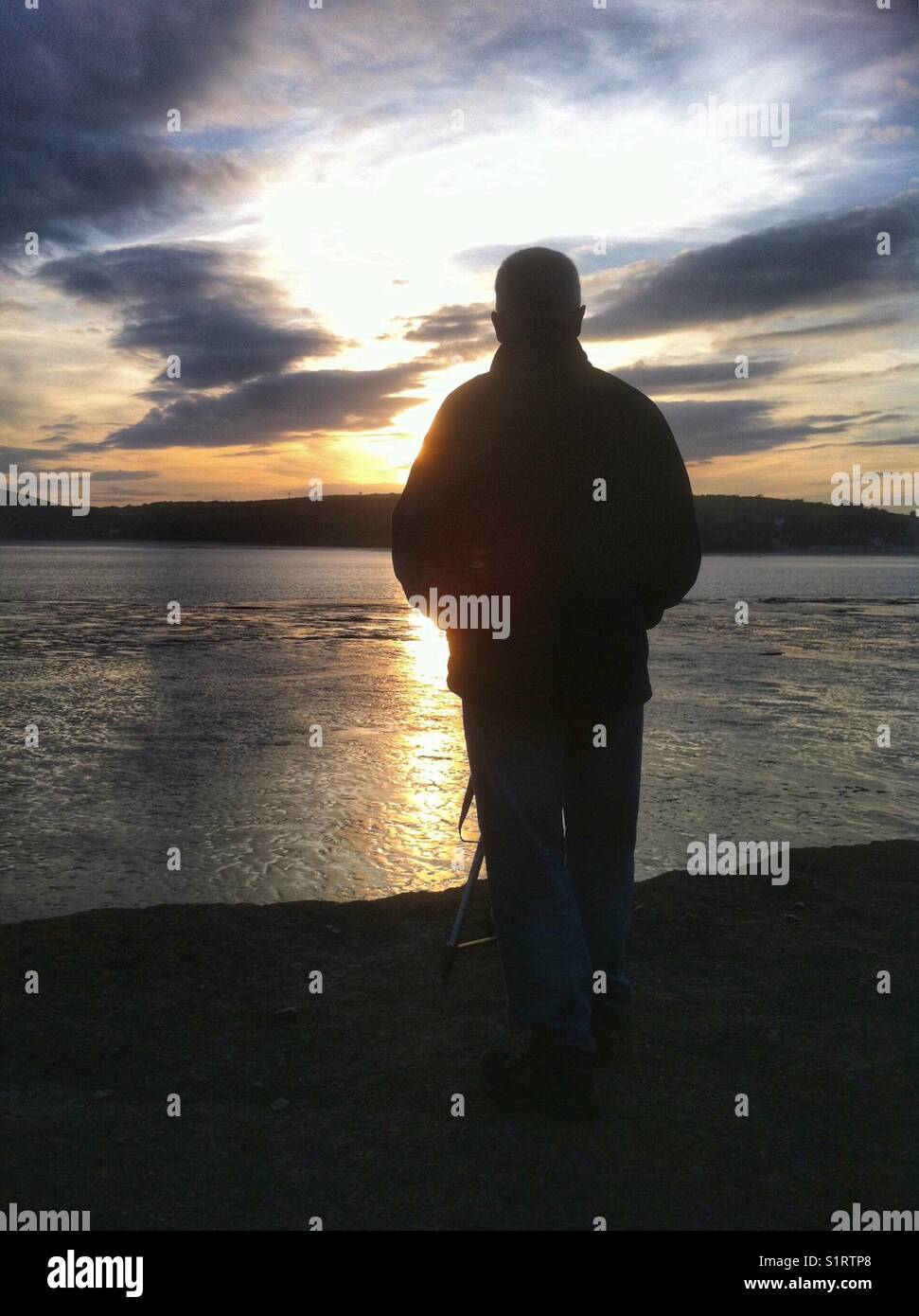 Man gazing at the sunset. Stock Photo