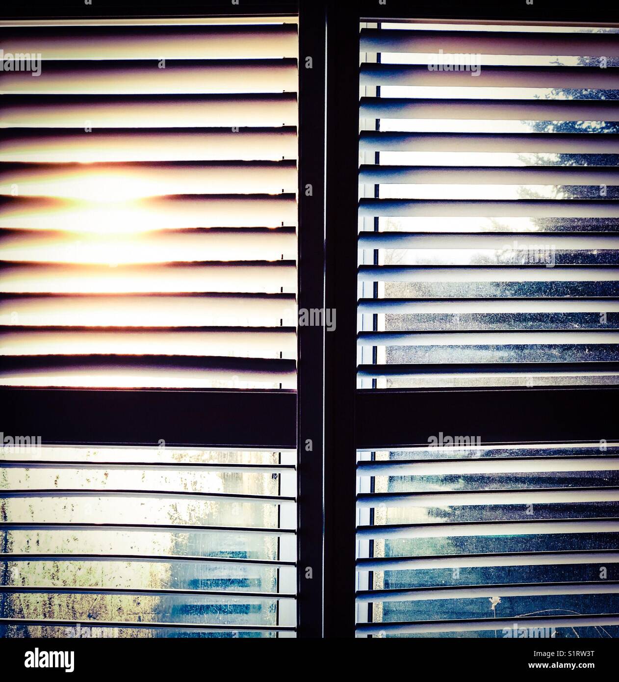 Morning sunrise through partially open window blinds - Smartphone Captured Stock Image