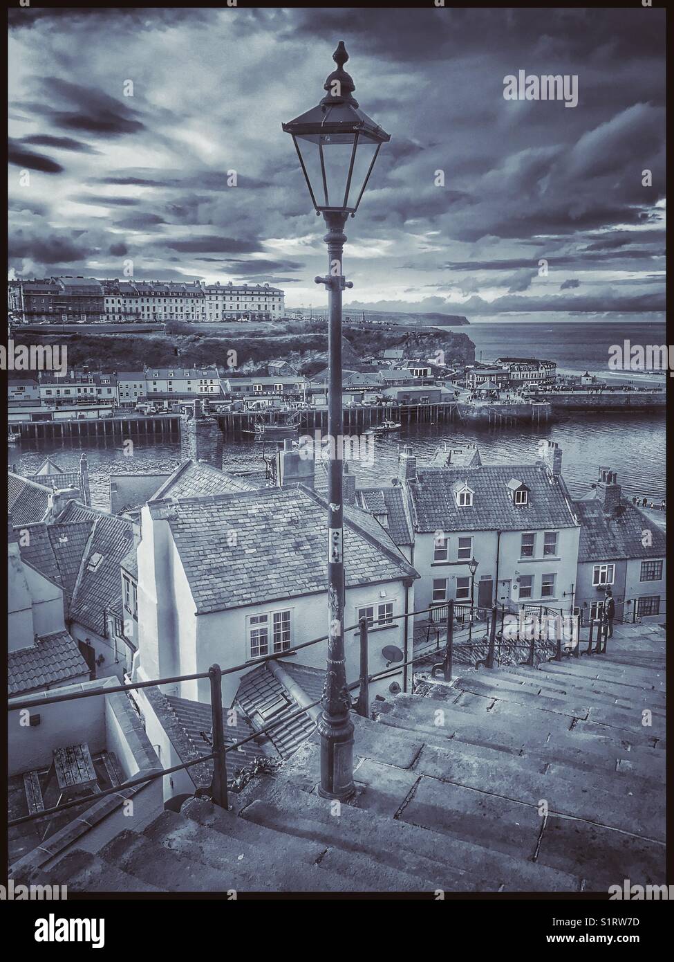 A view over Whitby, Yorkshire, England - from the famous 199 steps that connect The Old Town with St. Mary's Church. This area inspired parts of Bram Stoker's novel - 'Dracula' Photo © COLIN HOSKINS. Stock Photo