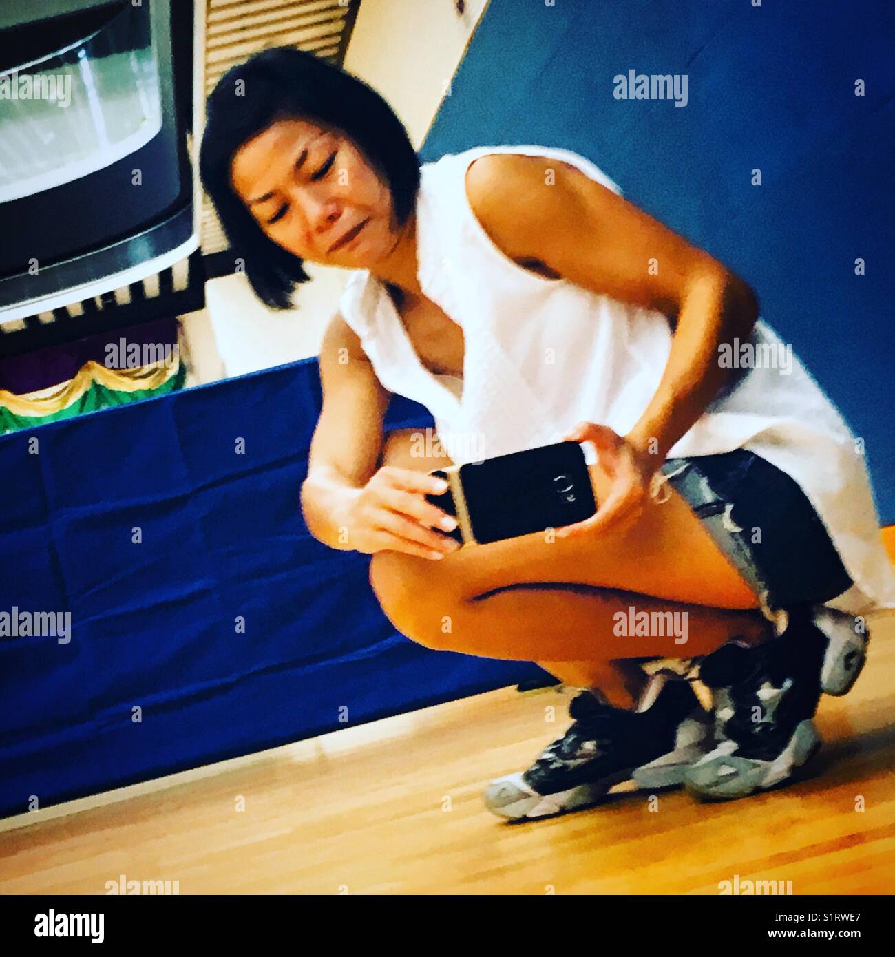 Chinese eoman taking a photo with her smartphone - Smartphone Captured Stock Image