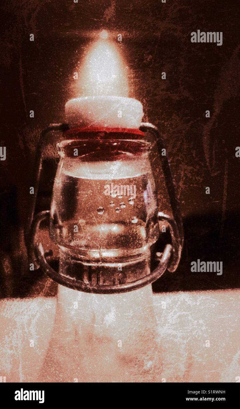 Metal clamp of glass water bottle under a spotlight Stock Photo Alamy