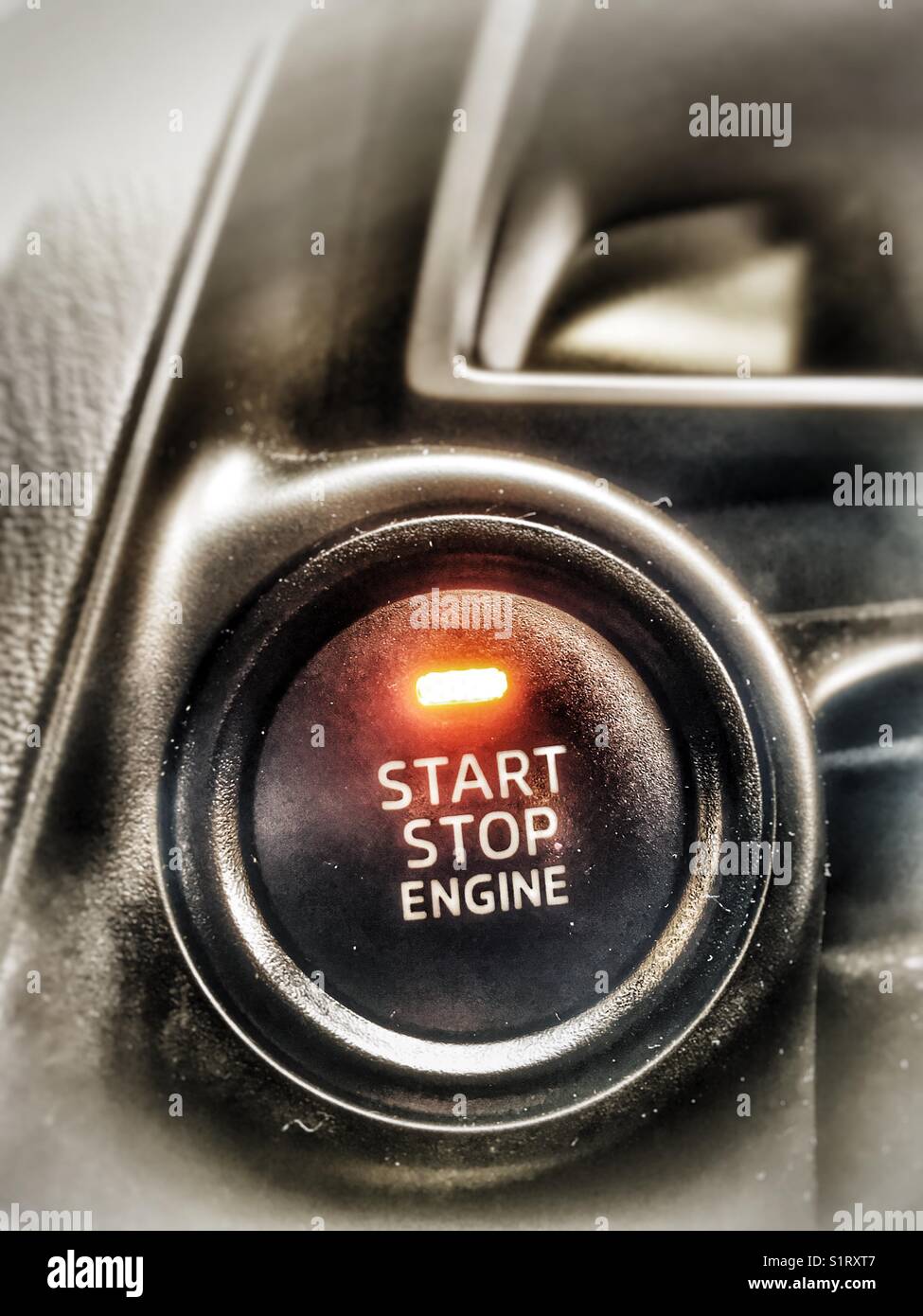 Start stop engine button in modern car - Smartphone Captured Stock Image