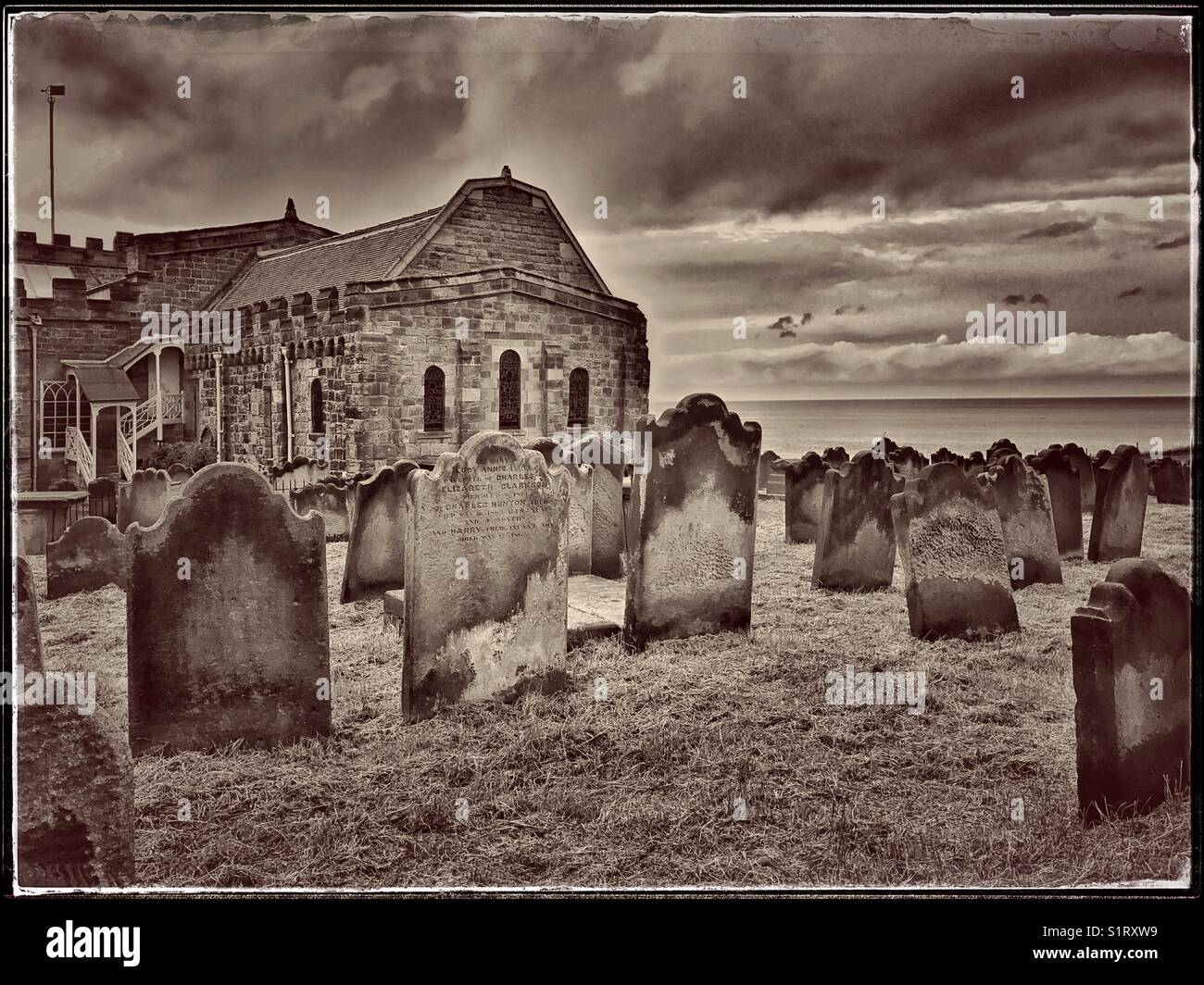 The Hill Top Church of Saint Mary in Whitby, Yorkshire, England. The view depicts the graveyard and North Sea on the horizon. This Church was made famous in the novel 'Dracula.' Photo © COLIN HOSKINS. - Smartphone Captured Stock Image