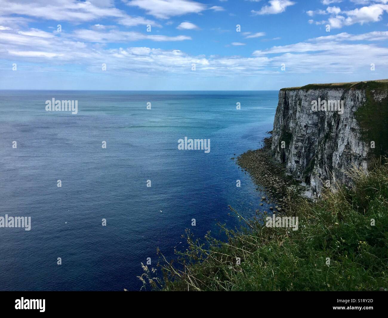 Blue sea, blue sky and high chalk cliffs at Bempton - Smartphone Captured Stock Image