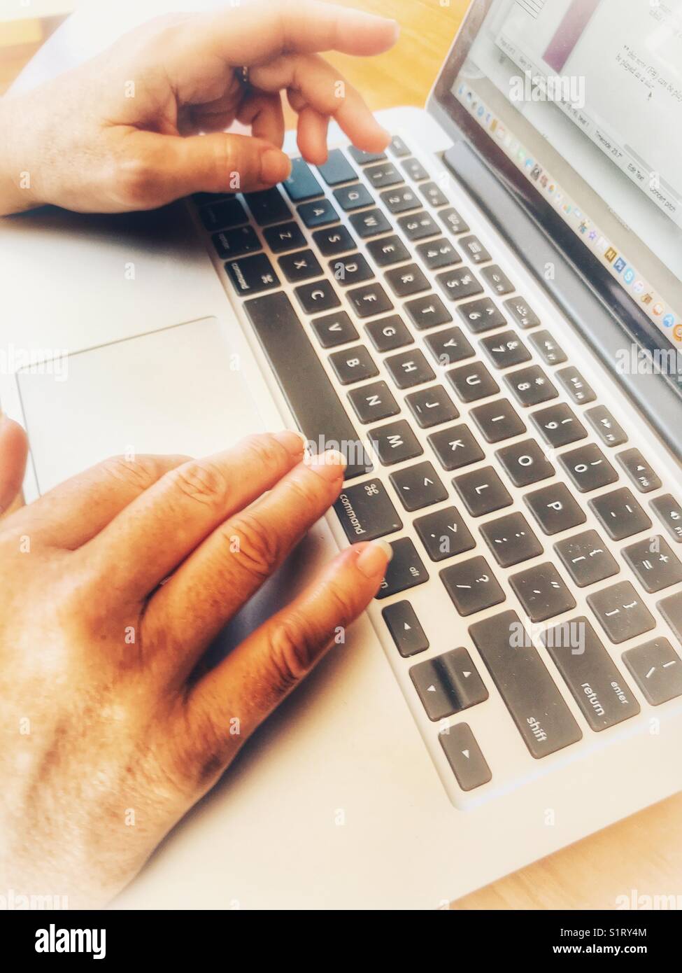 High angle view of woman’s hands and a laptop keyboard - Smartphone Captured Stock Image