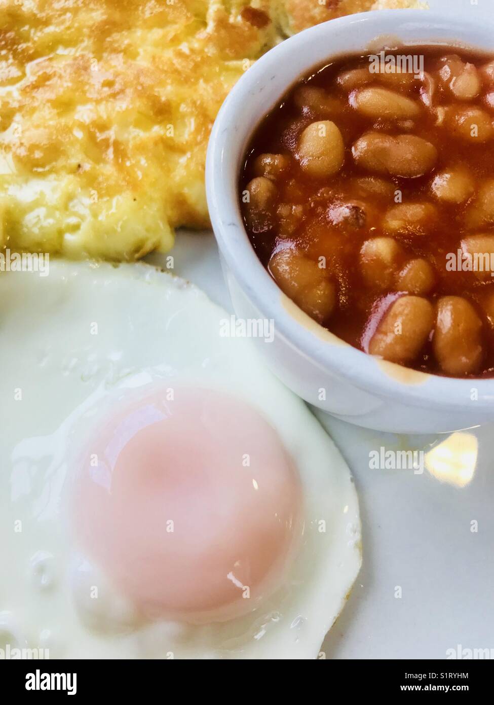 Breakfast with omelette, fried egg and baked beans Stock Photo Alamy