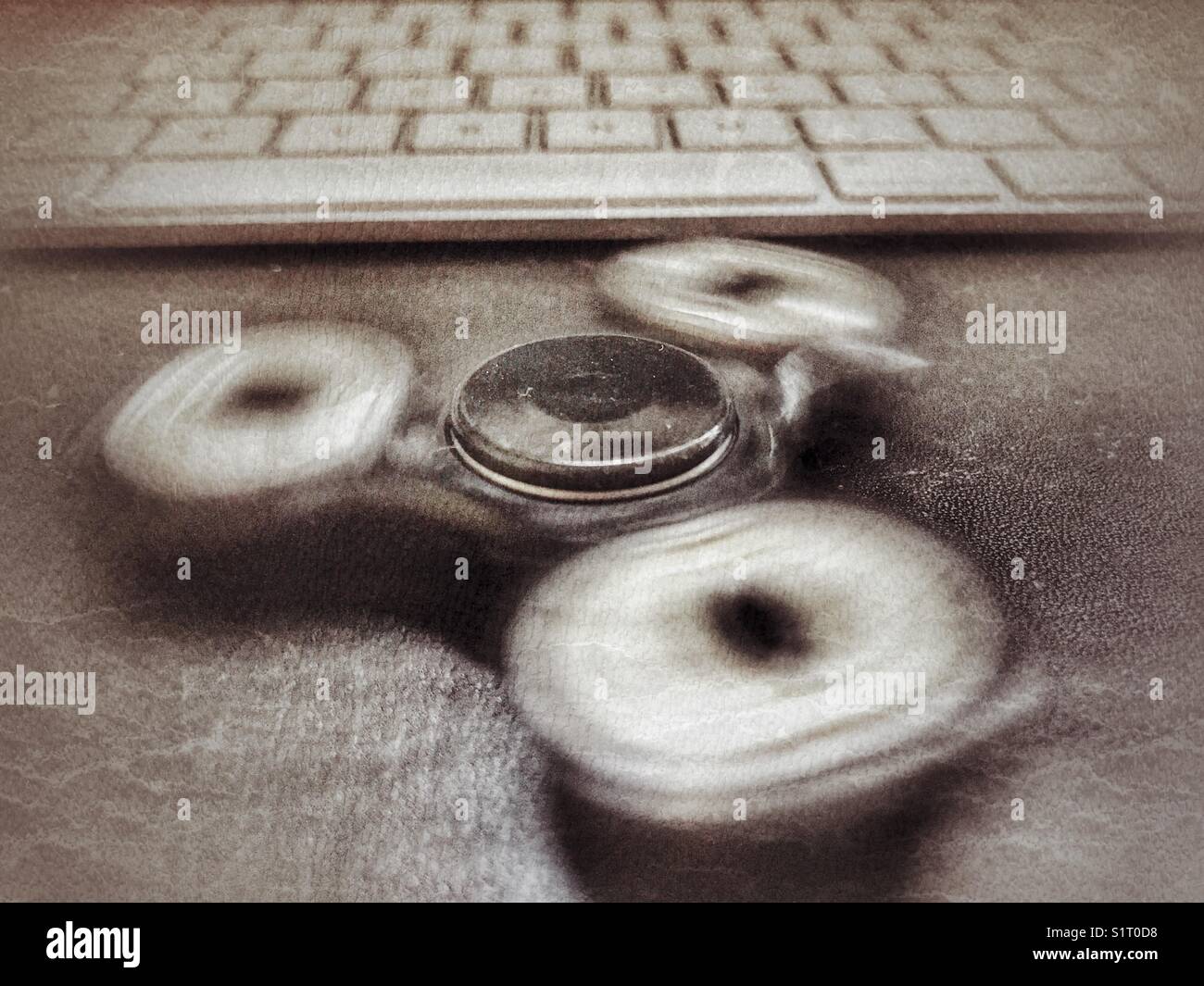 Fidget spinner, spinning, on a desk - Smartphone Captured Stock Image