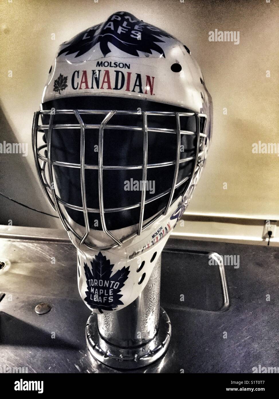 A Molson Canadian goalie’s mask covering a beer faucet. - Smartphone Captured Stock Image