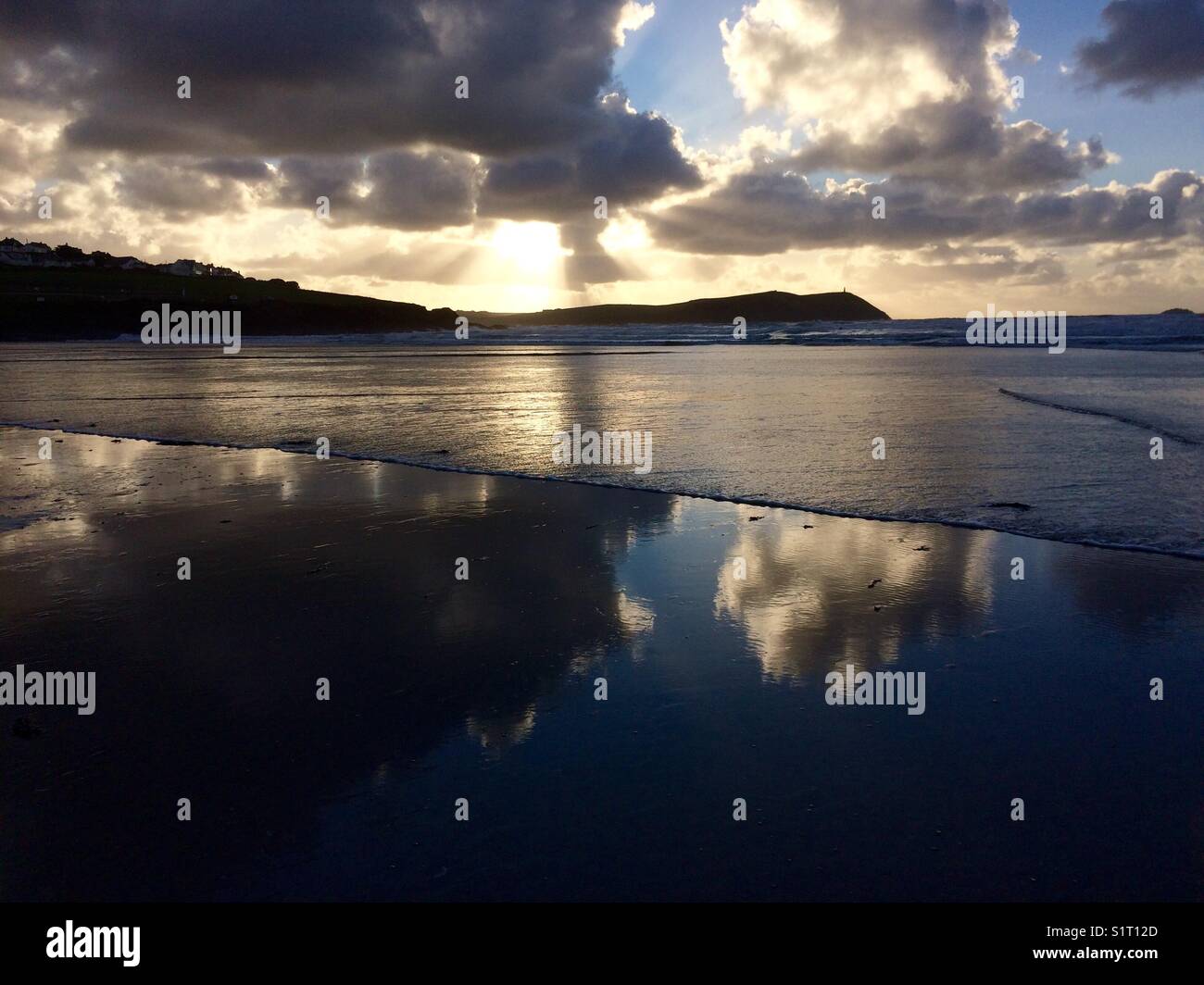Waves rolling up a beach in North Cornwall on an autumn afternoon as the sun goes down. - Smartphone Captured Stock Image