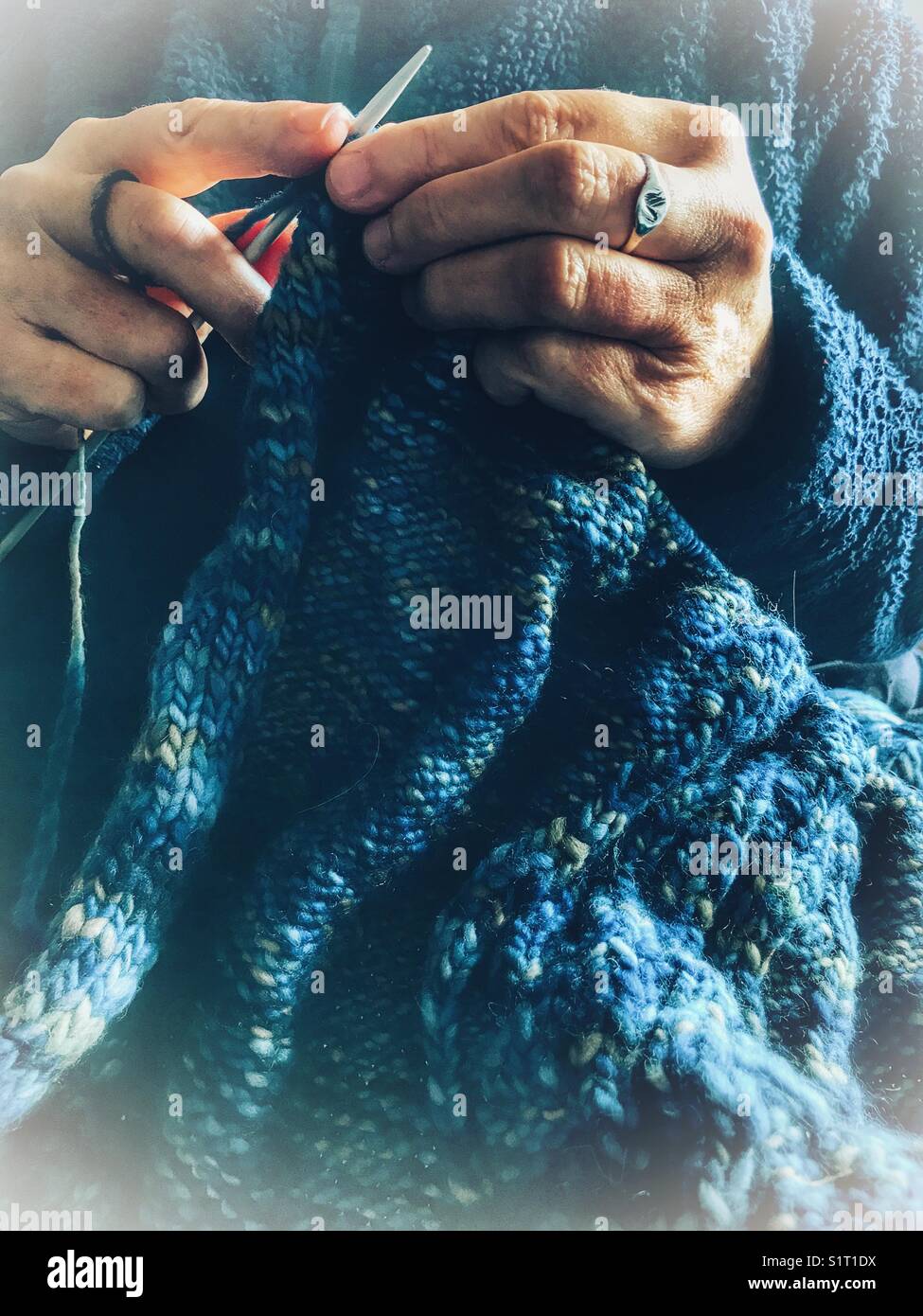 Woman knitting a sweater with hand-dyed hand-spun wool - Smartphone Captured Stock Image