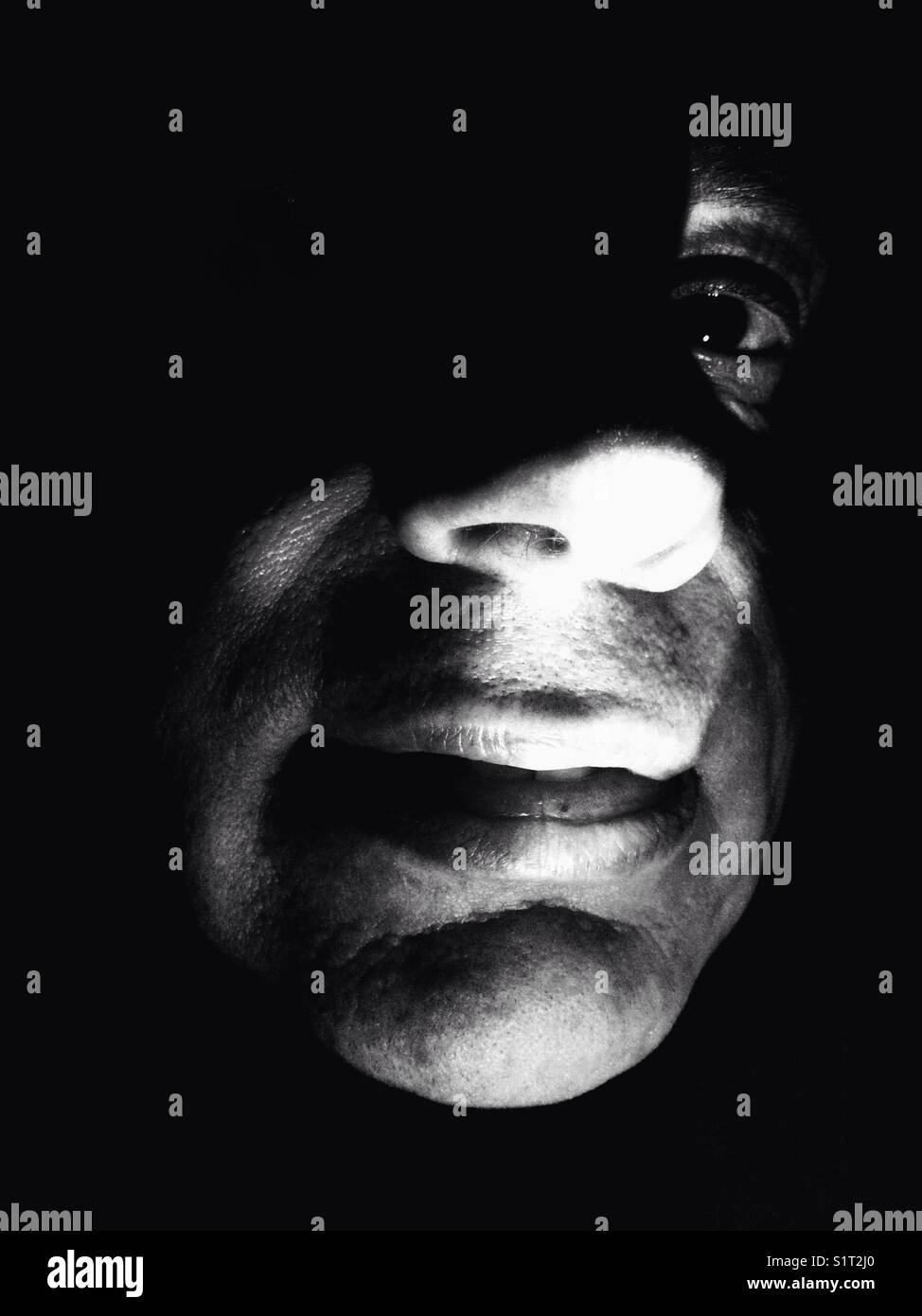 Eerie image of a mans face lit from underneath - Smartphone Captured Stock Image