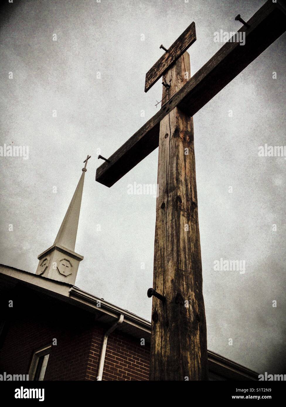 Rustic cross and church steeple Stock Photo - Alamy
