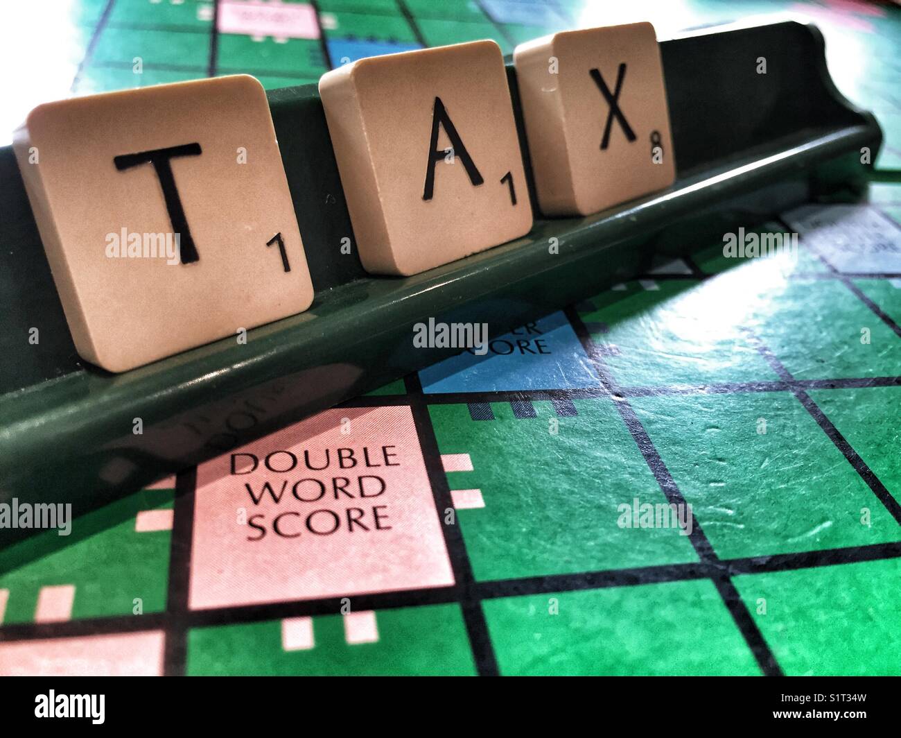The word Tax written with scrabble tiles - Smartphone Captured Stock Image