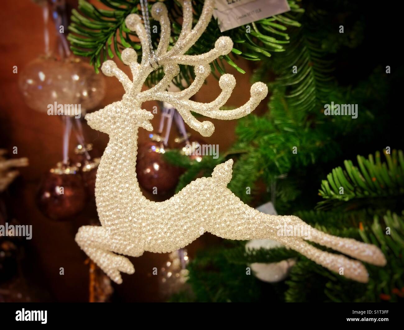 Reindeer Christmas decoration hanging on a tree - Smartphone Captured Stock Image