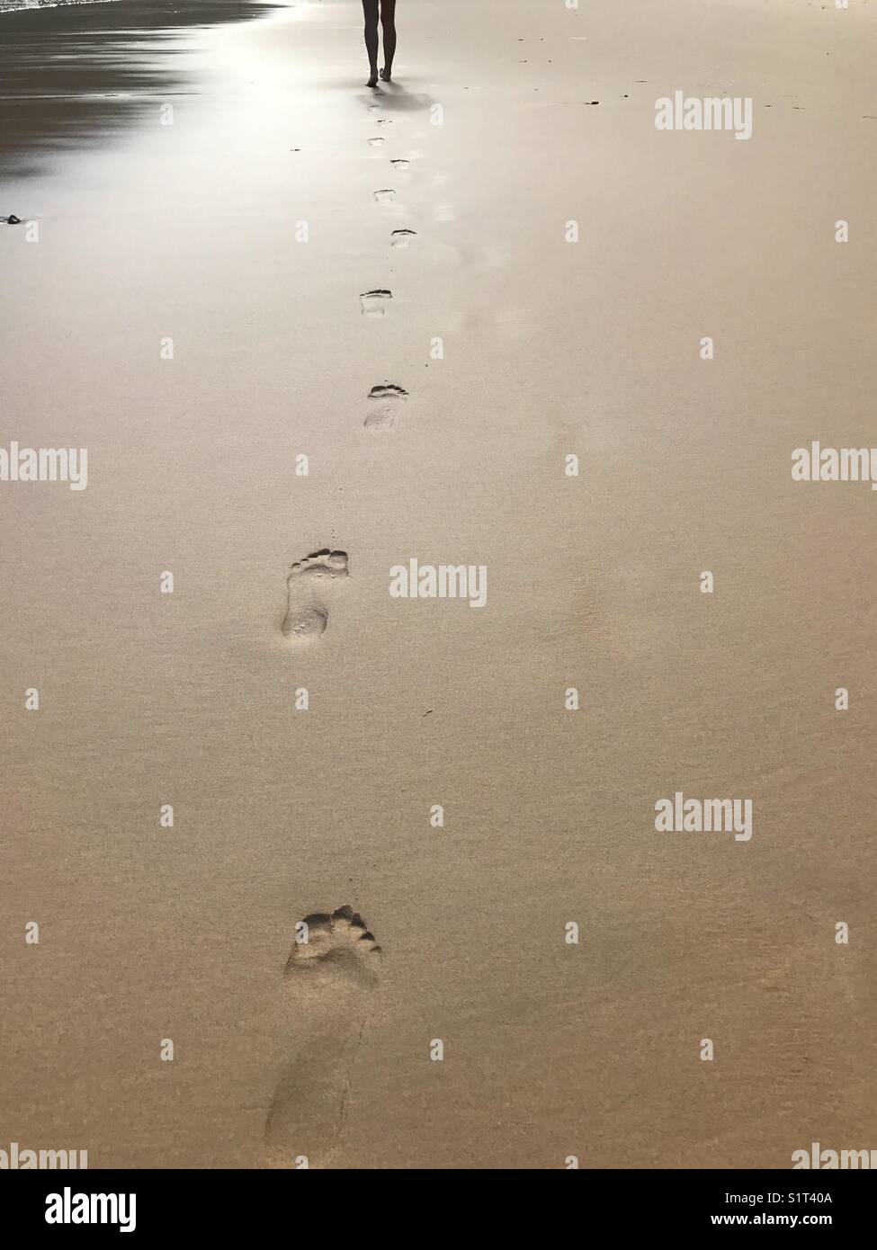 Footprints on wet sand. - Smartphone Captured Stock Image
