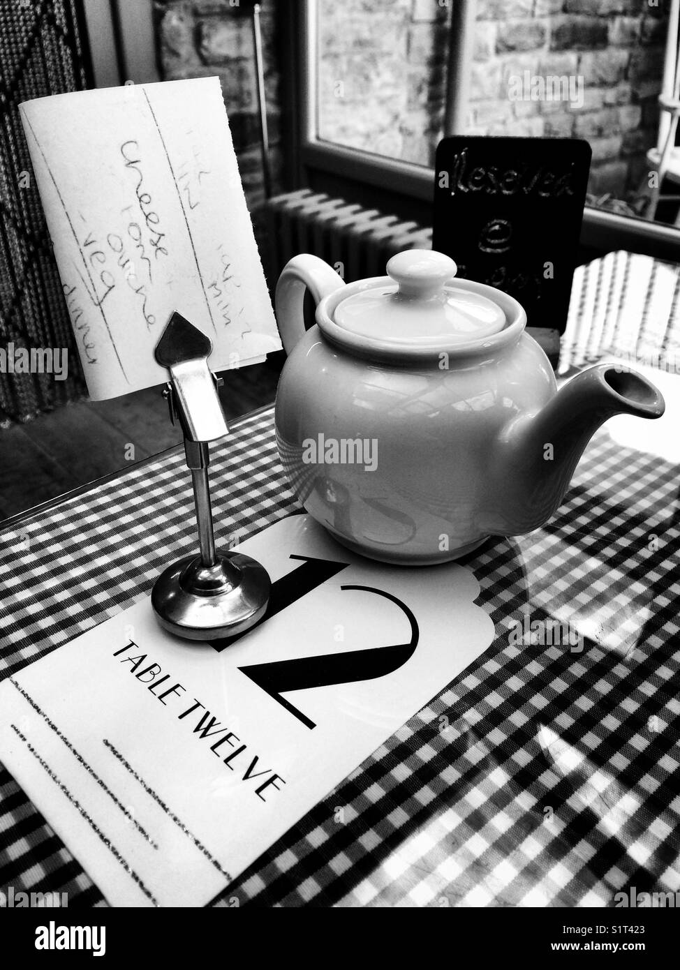 Tearoom table with pot of in black and white - Smartphone Captured Stock Image