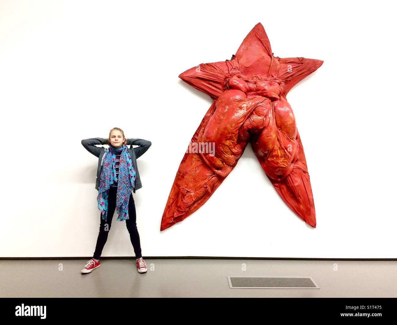 Teen girl cheerful posing at modern art exhibition Stock Photo