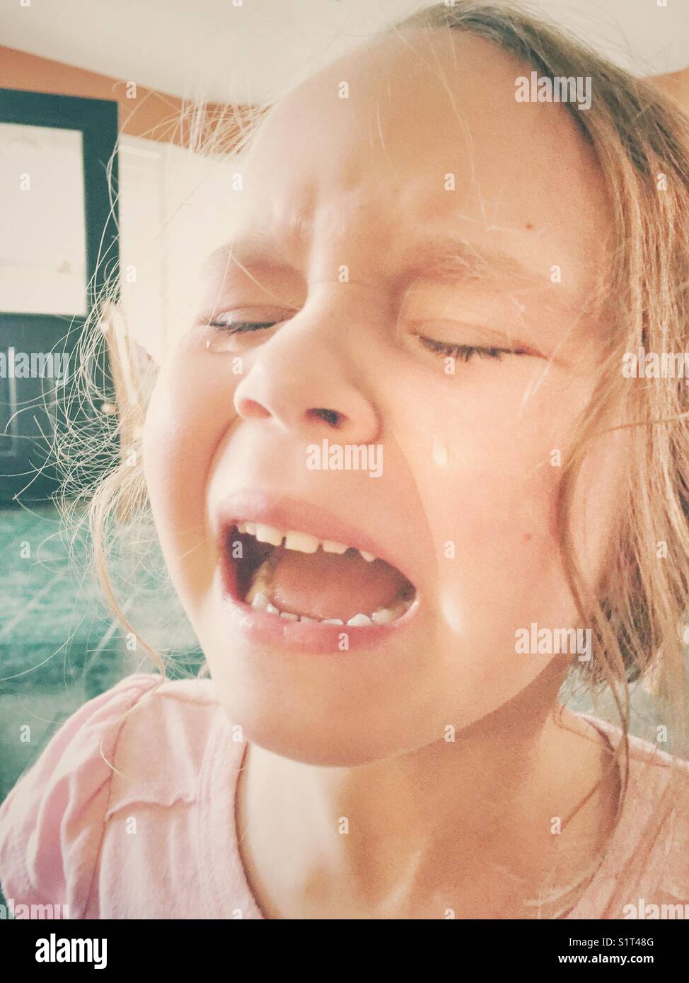 young-girl-crying-with-mouth-open-and-tears-falling-down-face-stock