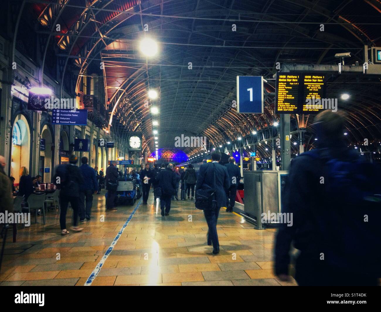 Passengers rush to board a train on platform 1 at Paddington Station in London. - Smartphone Captured Stock Image