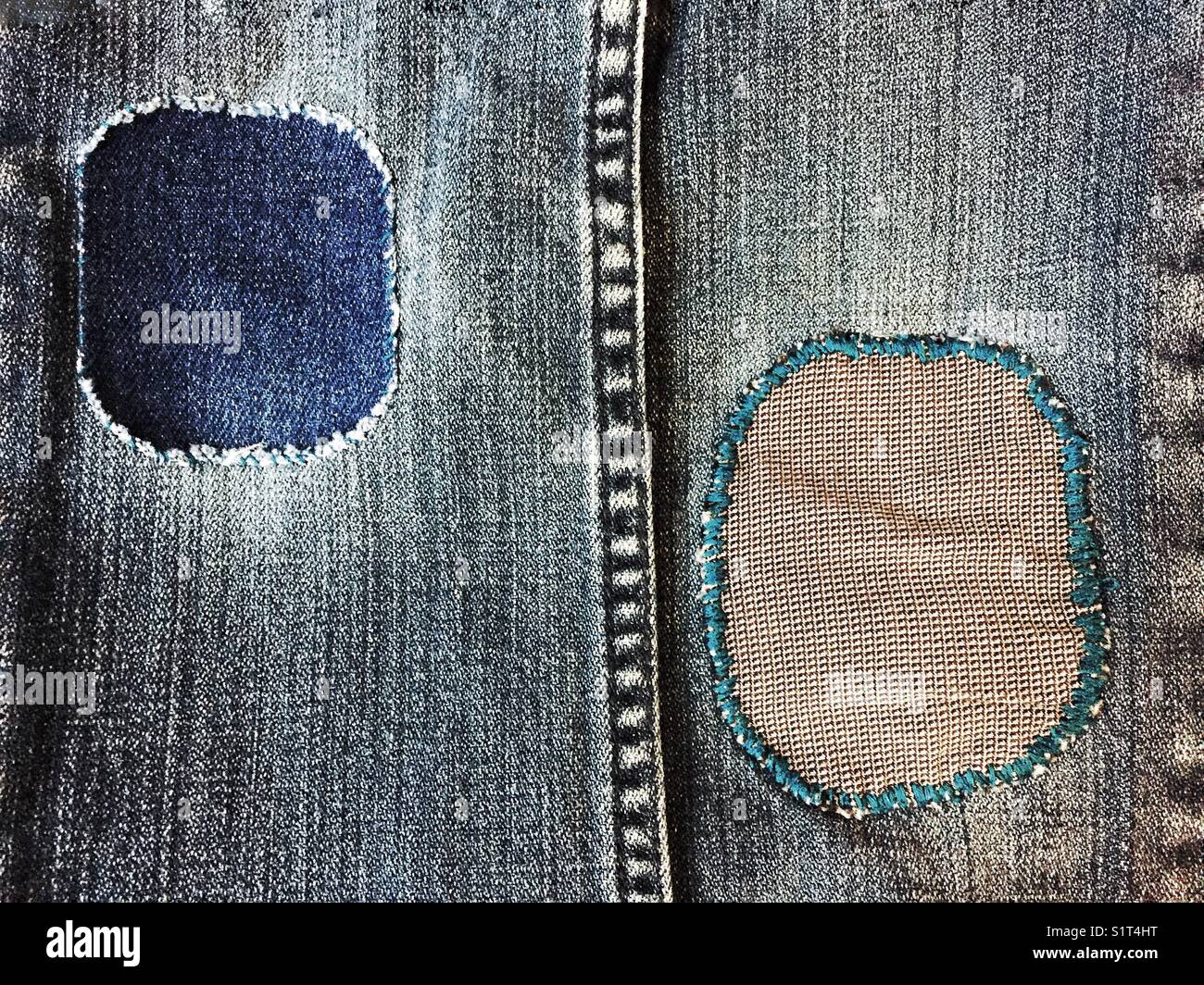 Repair patches on jeans Stock Photo Alamy