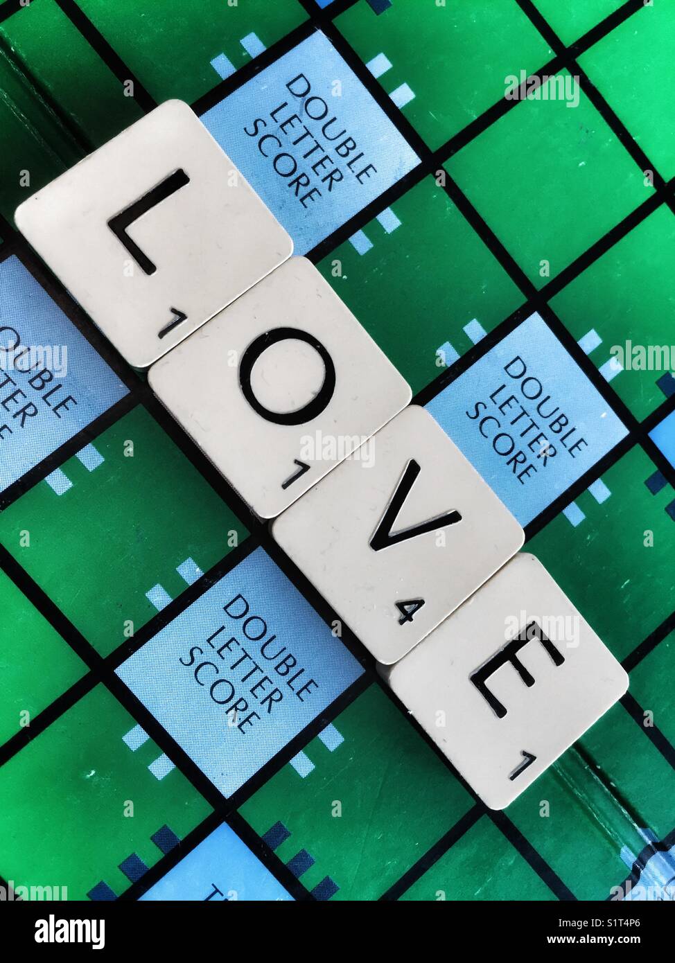 The word: Love written with scrabble tiles - Smartphone Captured Stock Image