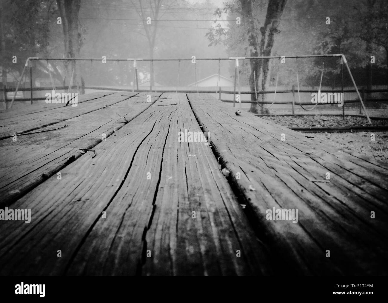 Black and white photo of picnic table and playground in the mist - Smartphone Captured Stock Image
