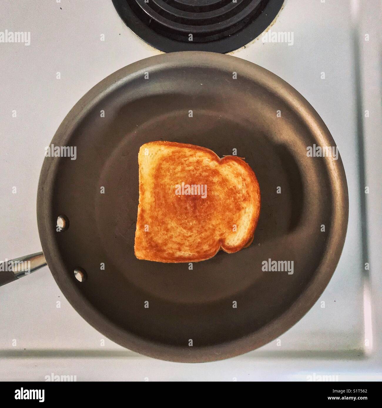 Grilled cheese sandwich in frying pan on stove Stock Photo Alamy