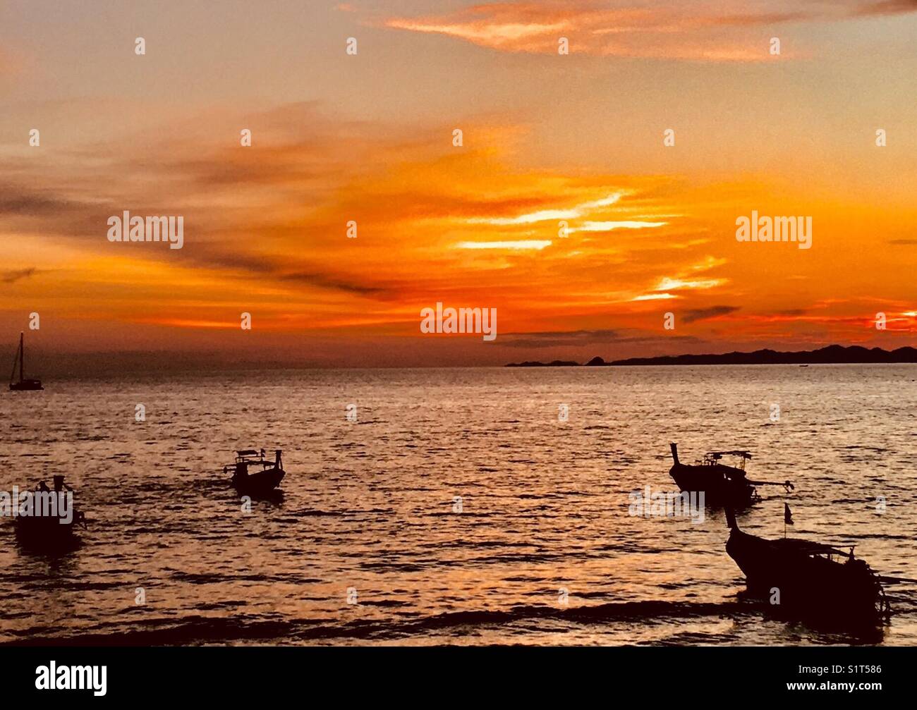 Ao Nang Thailand Sunset, complete with the signature long tailed boats Stock Photo