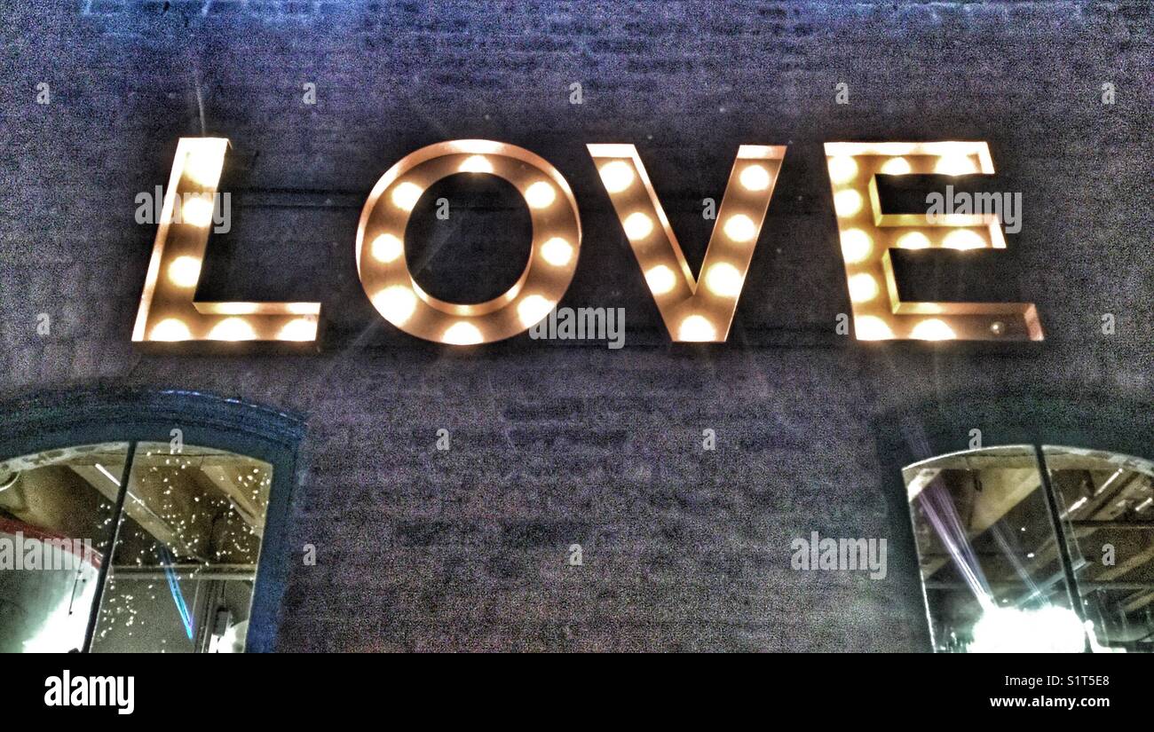 Neon sign spells the word love. - Smartphone Captured Stock Image